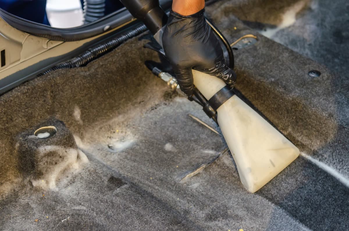 Vacuuming a car's interior upholstery